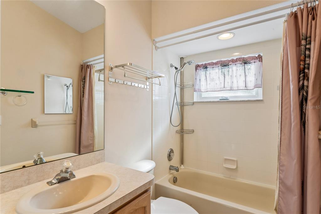 11330 Leeds Drive Spring Hill, FL 34609 - Photo 27 of 78 a bathroom with a granite countertop sink toilet and shower