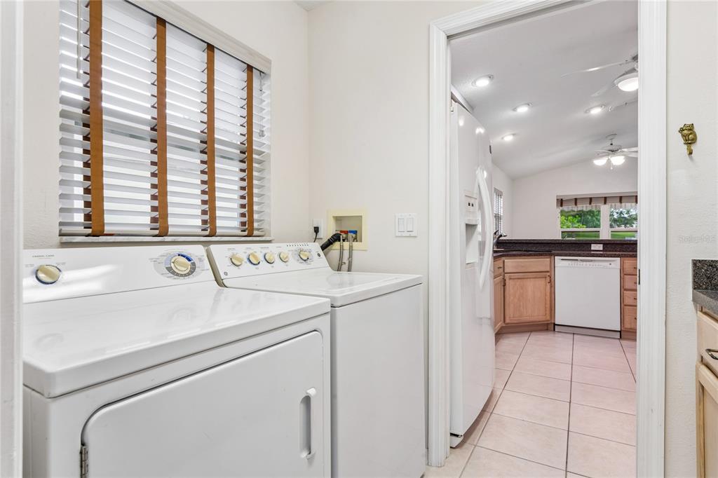 11330 Leeds Drive Spring Hill, FL 34609 - Photo 33 of 78 a view of washer and dryer with kitchen in the background