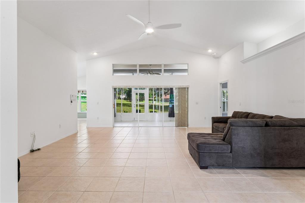 11330 Leeds Drive Spring Hill, FL 34609 - Photo 4 of 78 a living room with furniture and a floor to ceiling window