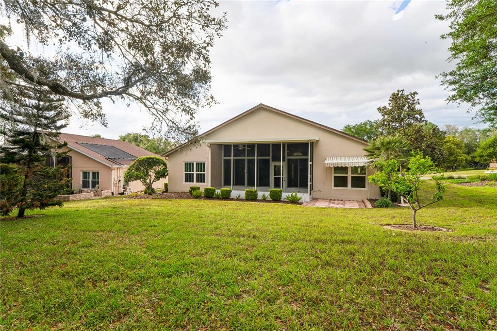 11330 Leeds Drive Spring Hill, FL 34609 - Photo 41 of 78 a front view of a house with a garden and trees