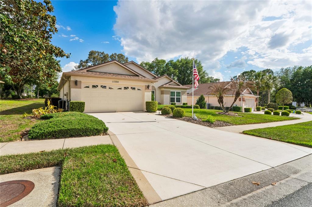 11330 Leeds Drive Spring Hill, FL 34609 - Photo 44 of 78 a front view of a house with a yard and garage