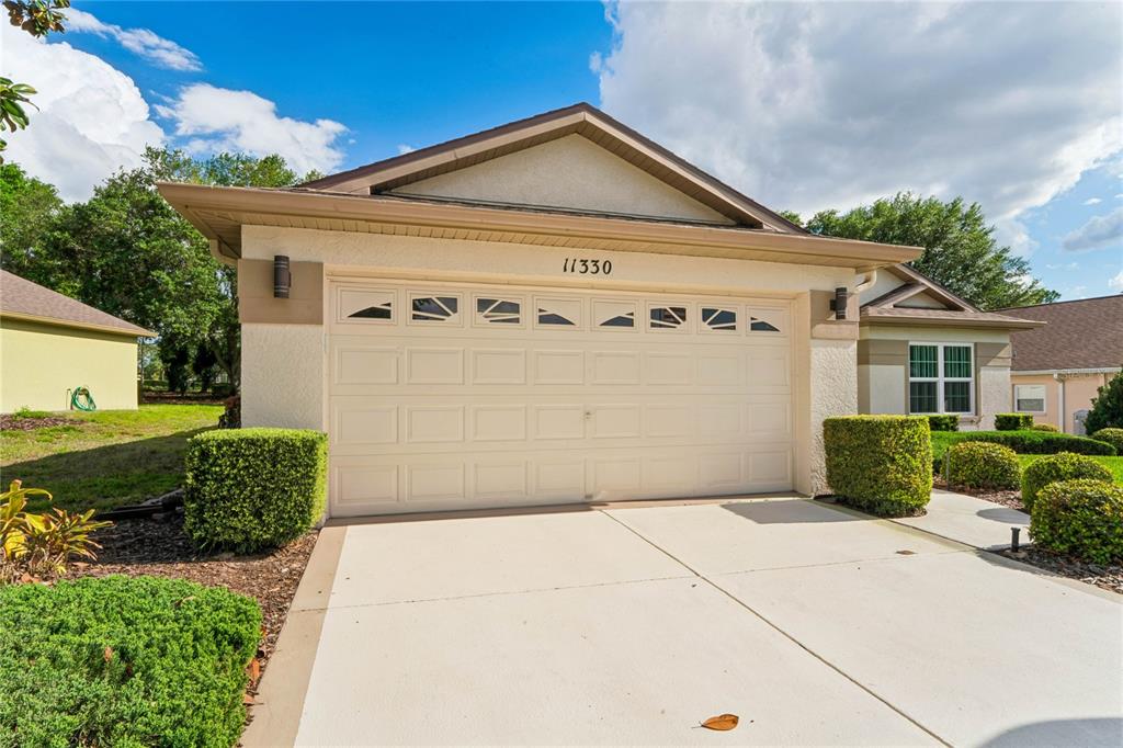 11330 Leeds Drive Spring Hill, FL 34609 - Photo 45 of 78 a front view of a house with a yard