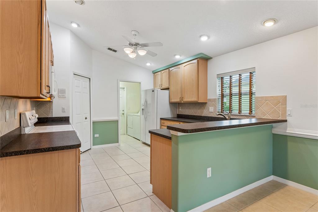 11330 Leeds Drive Spring Hill, FL 34609 - Photo 9 of 78 a kitchen with kitchen island granite countertop a sink a counter top space stainless steel appliances and cabinets