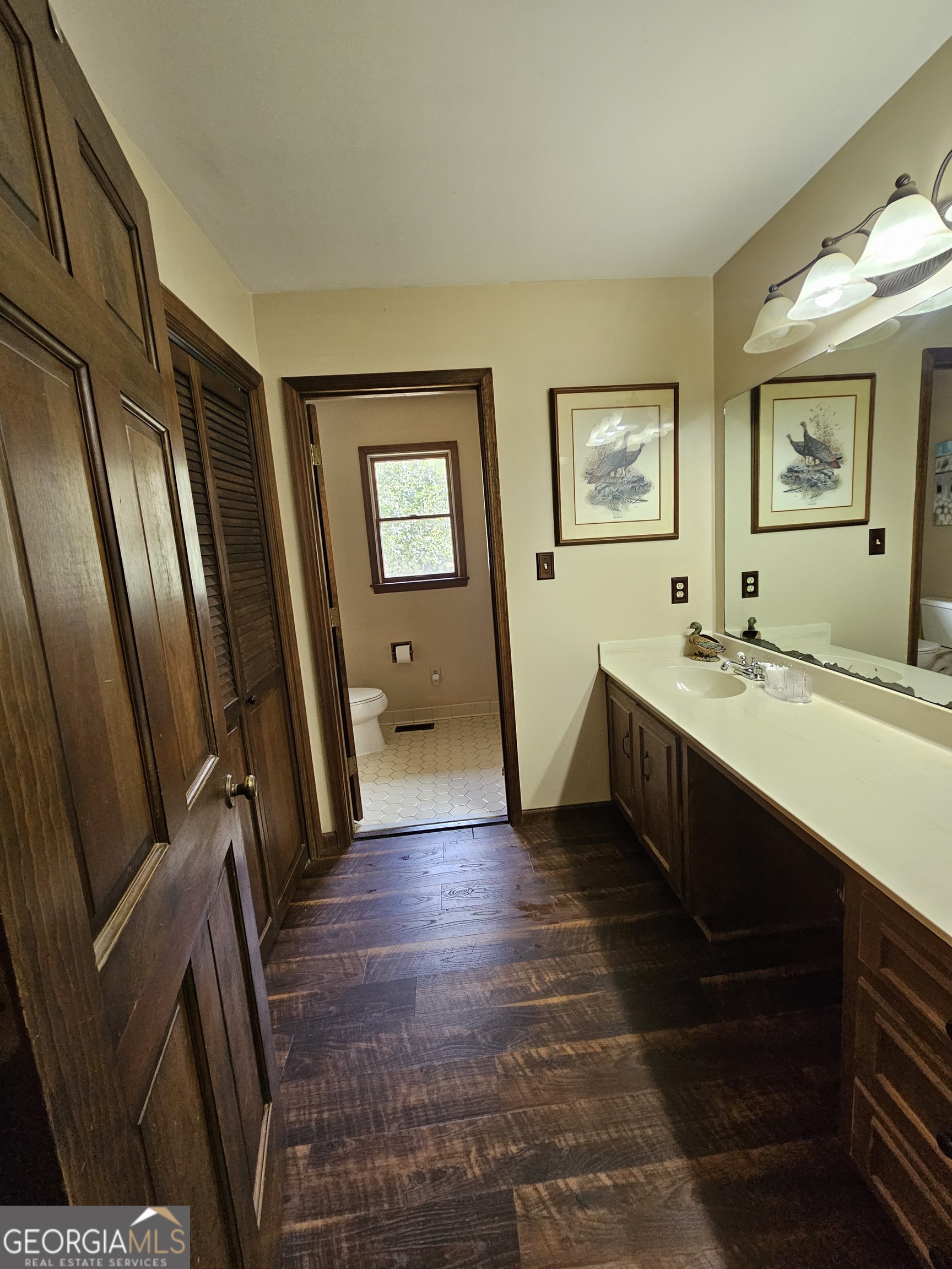 228 Honeysuckle Road Monticello, GA 31064 - Photo 18 of 35 a spacious bathroom with a bathtub sink and mirror