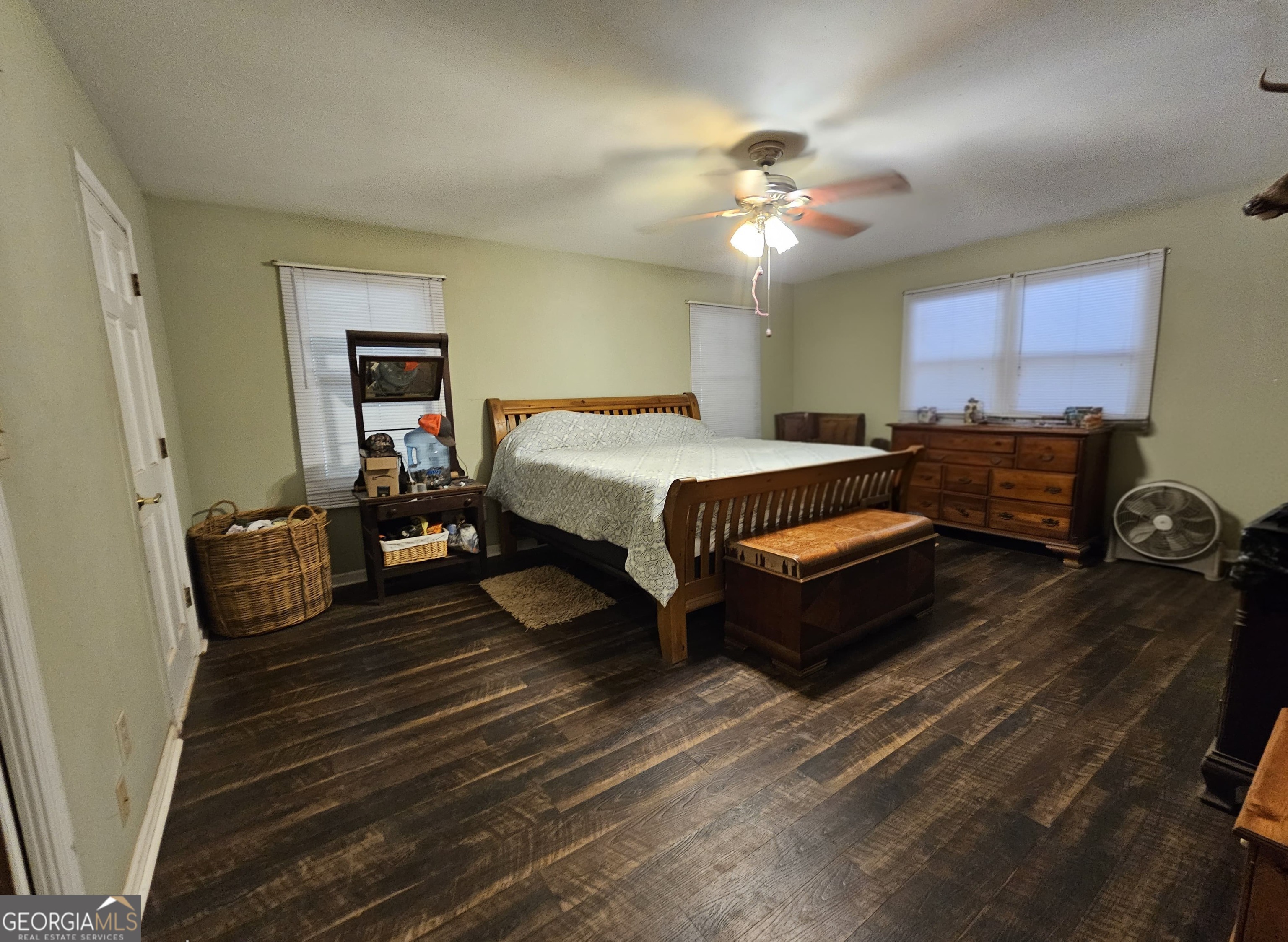228 Honeysuckle Road Monticello, GA 31064 - Photo 23 of 35 a spacious bedroom with a bed and a chandelier