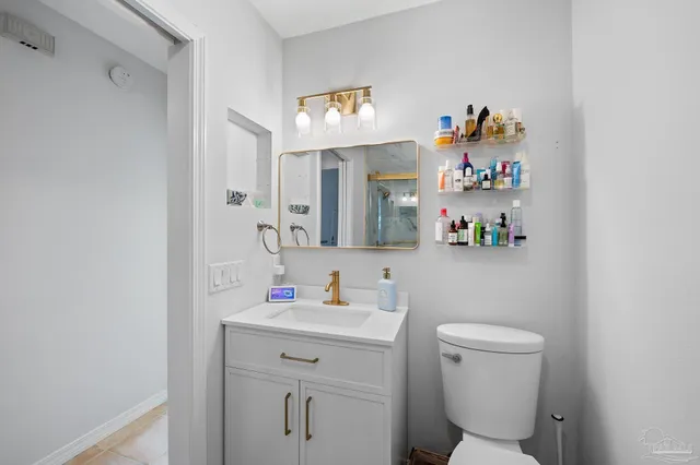 a bathroom with a sink mirror and toilet