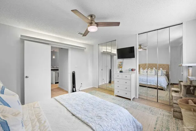 a bedroom with a bed and a flat screen tv