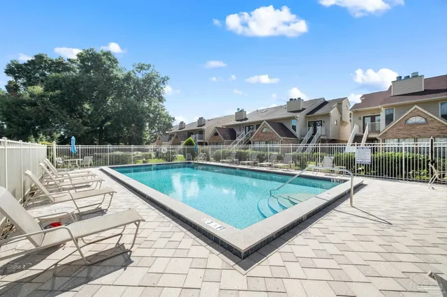 a view of a swimming pool with a lounge chairs