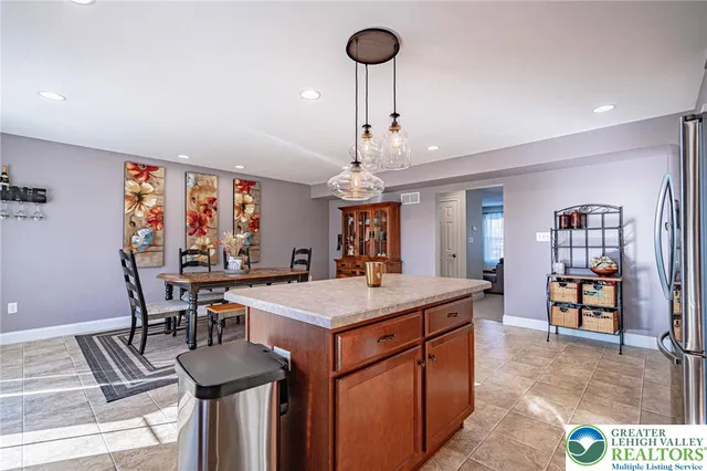 a view of a dining room with furniture a chandelier and wooden floor