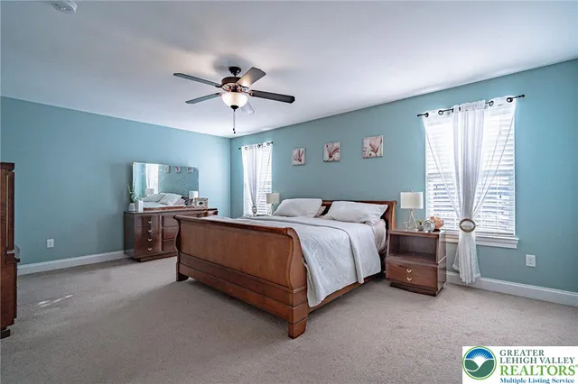 a spacious bedroom with a bed and a chandelier