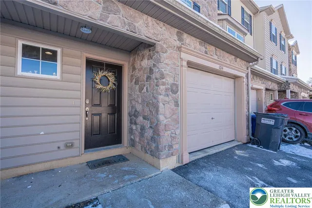 a view of a wooden door and a building