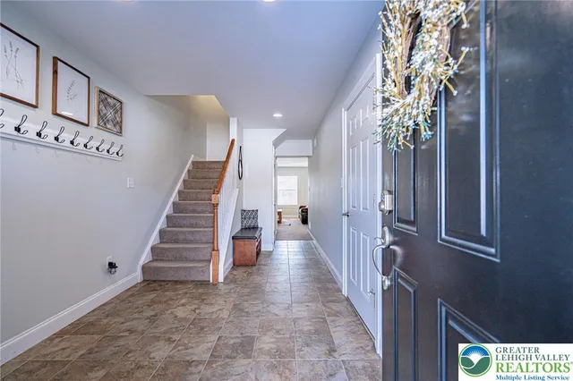 a view of entryway and hall with a front door