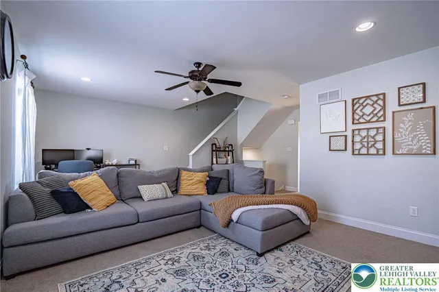 a living room with furniture and stairs