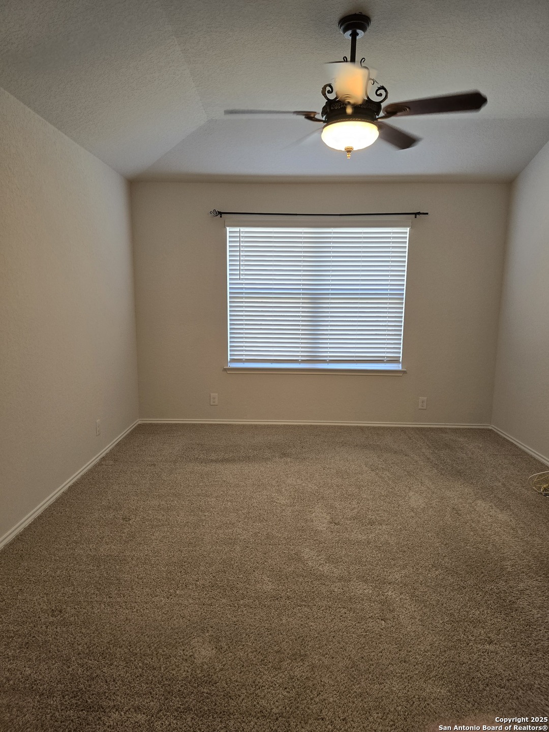 8207 Tortoise Trail Converse, TX 78109 - Photo 19 of 30 an empty room with a window and a ceiling fan