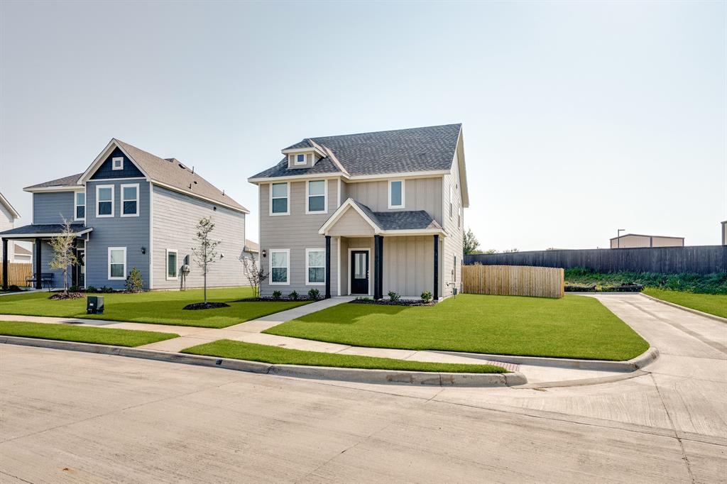 a view of a big house with a big yard and large trees