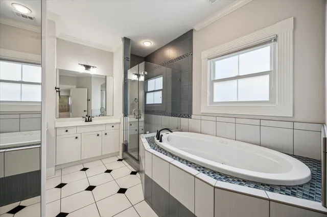 a bathroom with a granite countertop sink mirror and bathtub