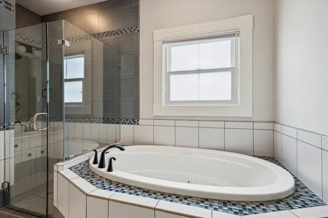a bathroom with a bathtub and shower