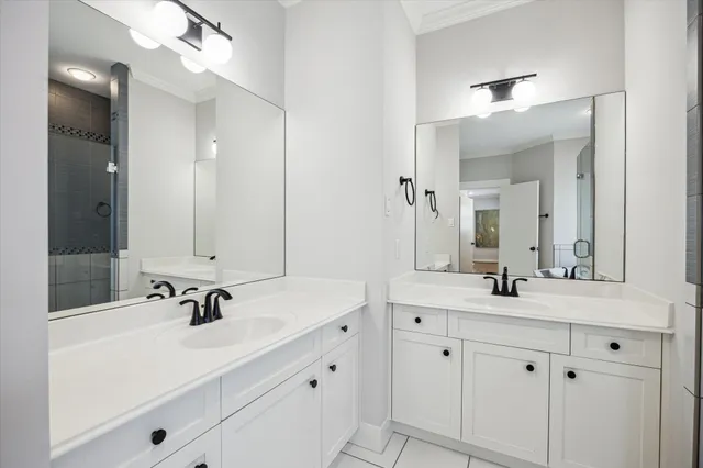 a bathroom with a sink double vanity and a mirror