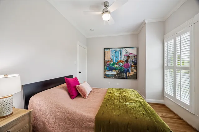 a bedroom with a bed and a painting on the wall