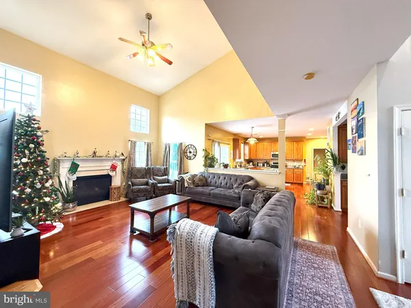 a living room with furniture a fireplace and a large window