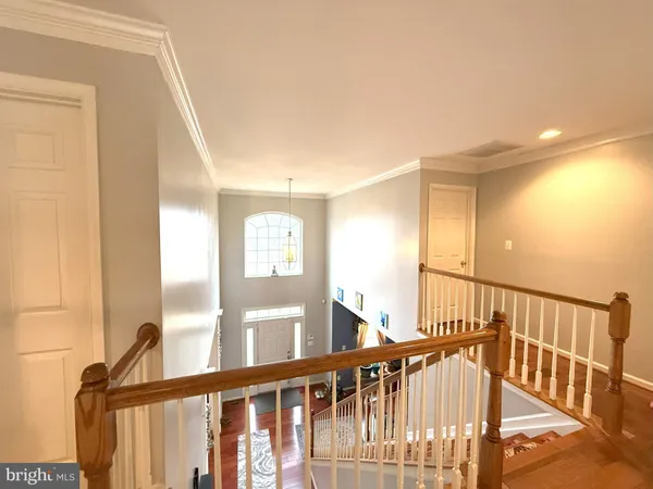 a view of staircase with railing and a window