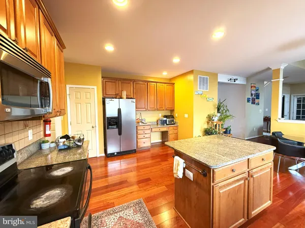 a kitchen with a stove a refrigerator and a sink