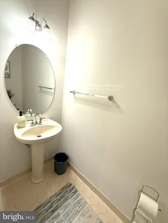 a bathroom with a sink toilet and mirror