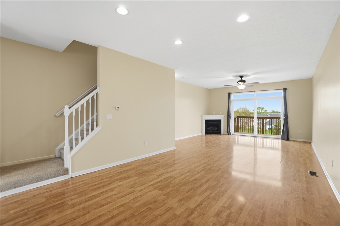 4324 Straight Arrow Road Dayton, OH 45430 - Photo 10 of 40 This airy living space features a fireplace, a ceiling fan, and access to an outdoor balcony.