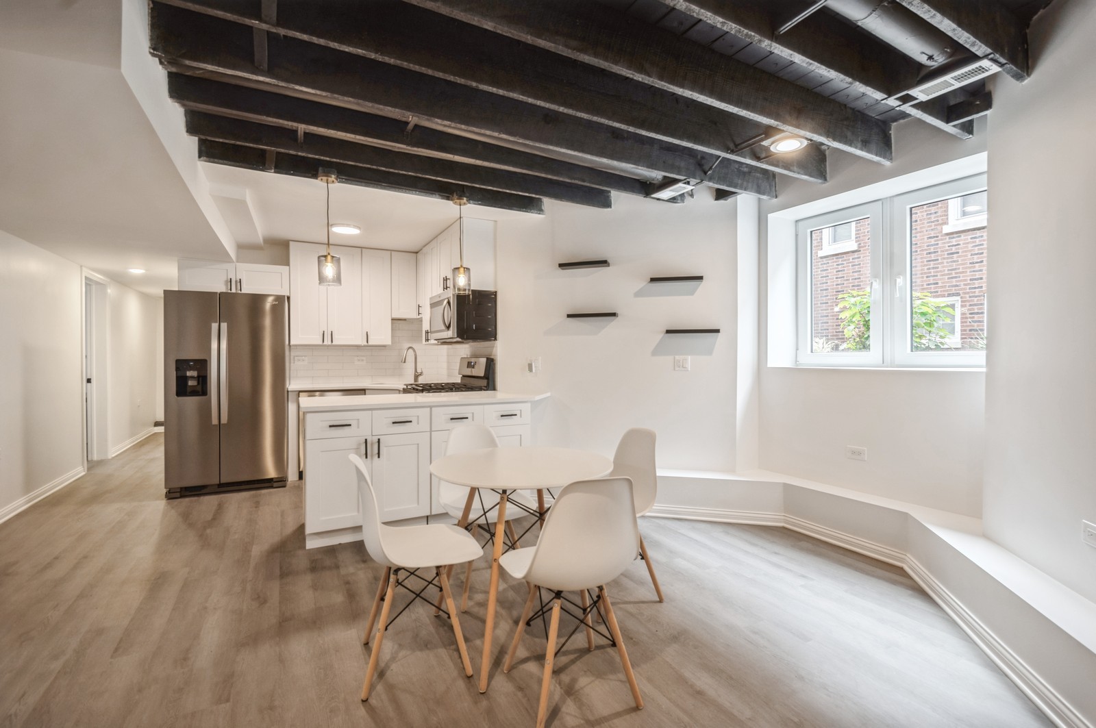 1823 Wesley Avenue, Unit G Evanston, IL 60201 - Photo 2 of 6 a kitchen with stainless steel appliances kitchen island granite countertop a dining table chairs and refrigerator