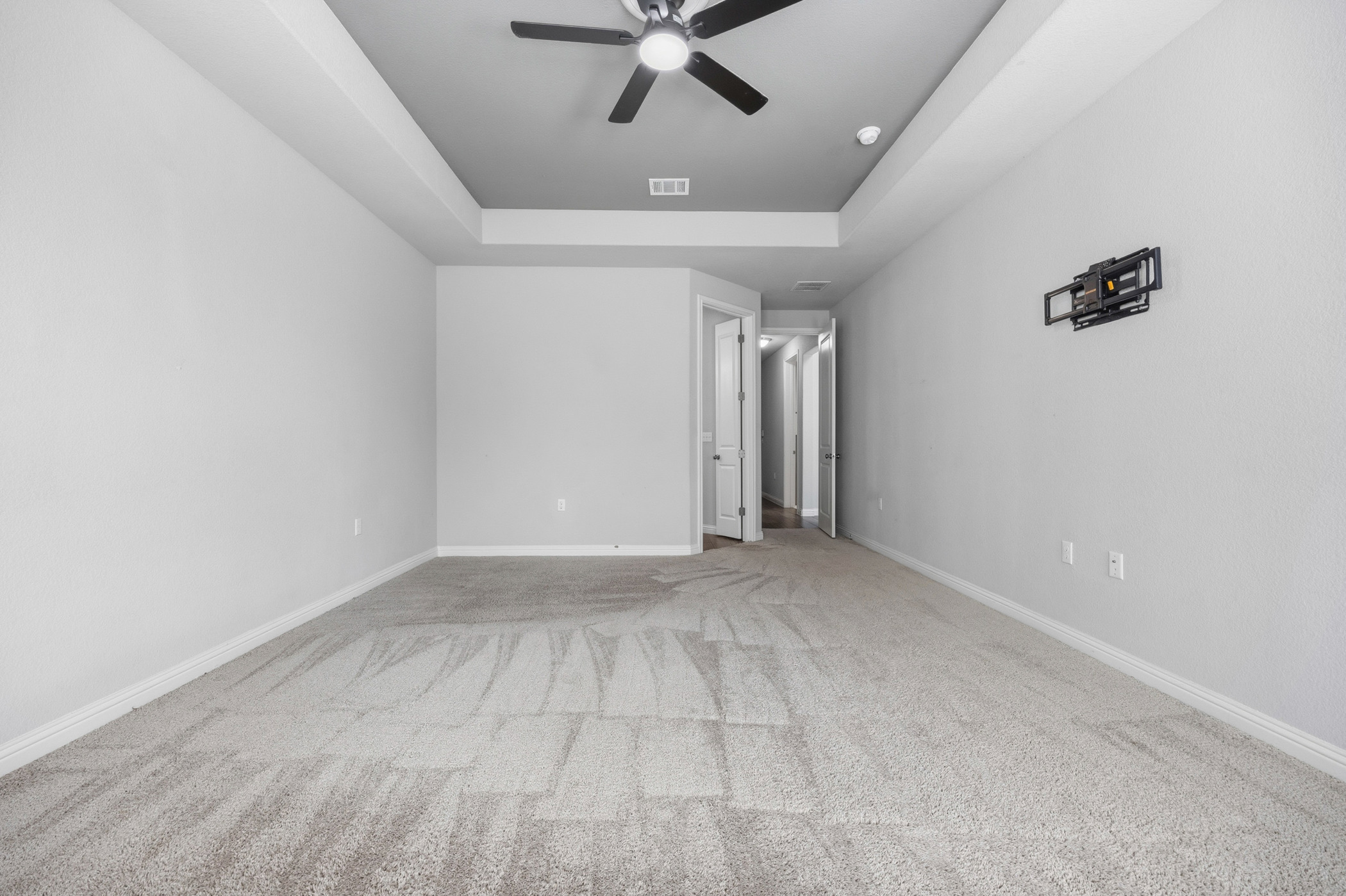 2209 Littleleaf Lane Leander, TX 78641 - Photo 14 of 27 Spare room with a ceiling fan, a raised ceiling, and light carpet