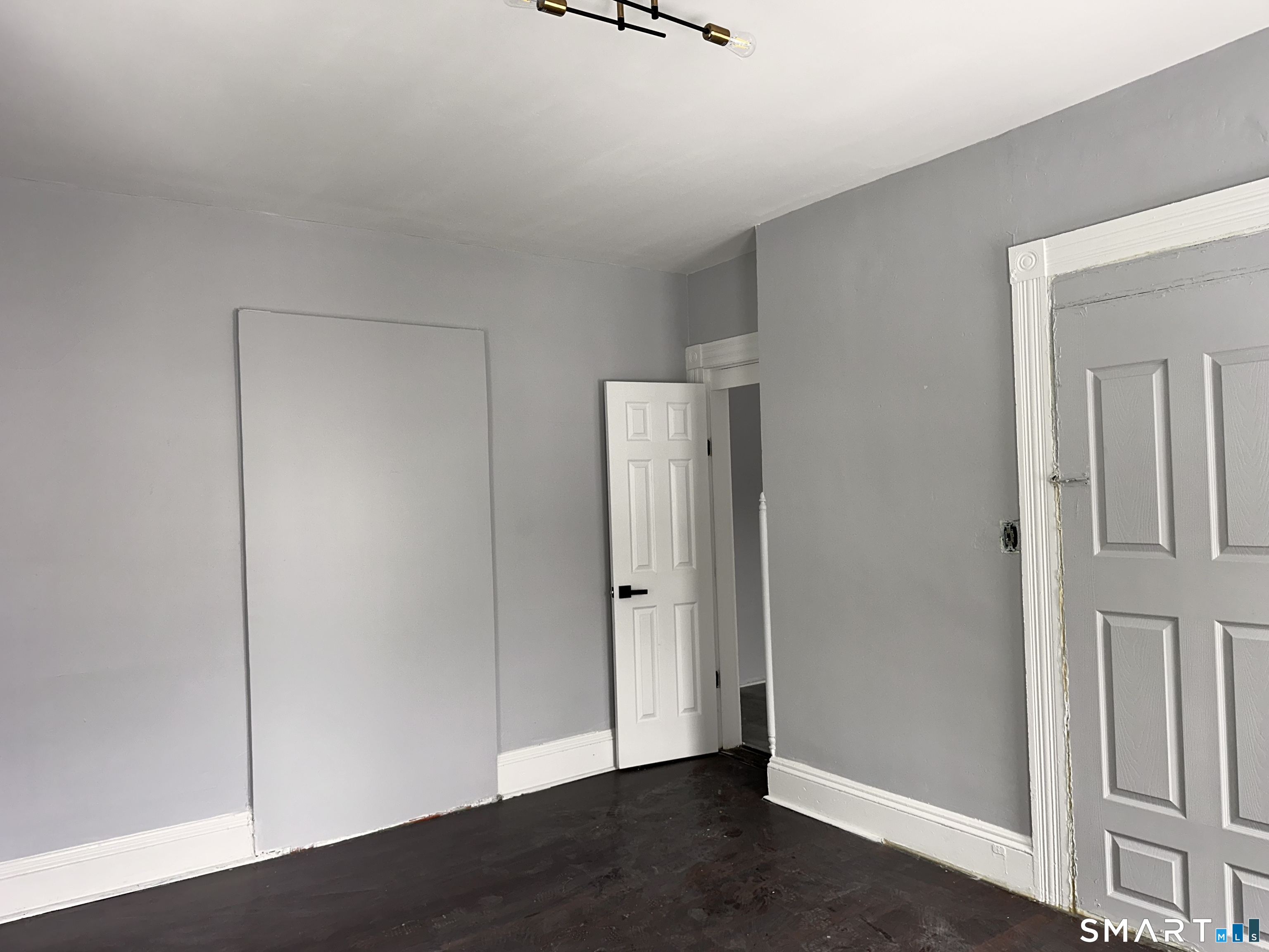 240 Madison Avenue Bridgeport, CT 06604 - Photo 12 of 21 an empty room with wooden floor and mirror