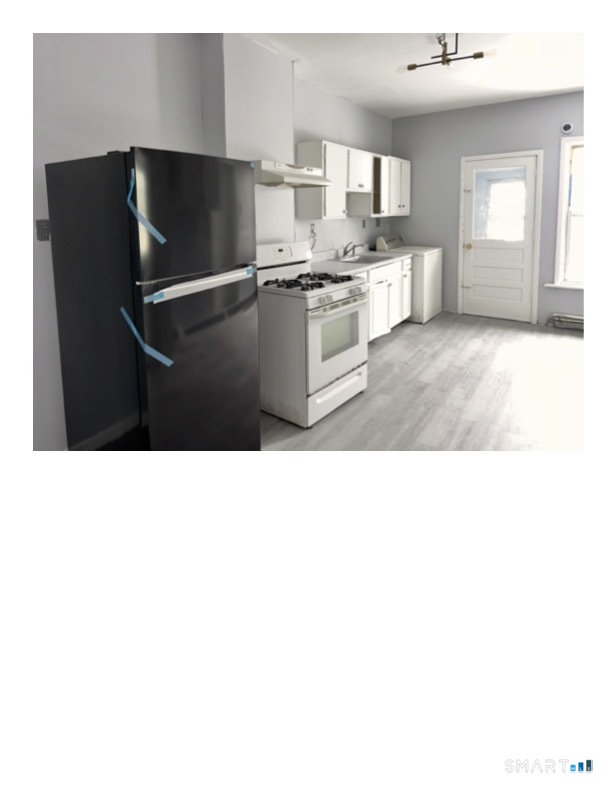 240 Madison Avenue Bridgeport, CT 06604 - Photo 3 of 21 a kitchen with stainless steel appliances granite countertop a refrigerator and a sink