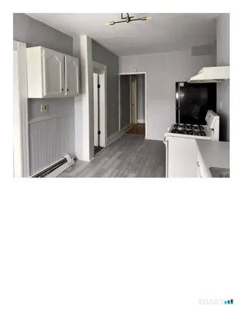 a kitchen with stainless steel appliances kitchen island sink refrigerator and stove