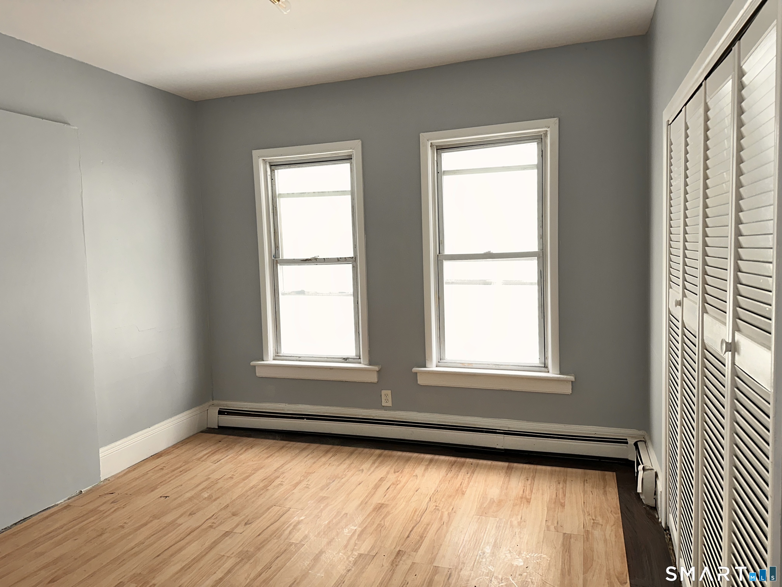 240 Madison Avenue Bridgeport, CT 06604 - Photo 7 of 21 a view of an empty room with wooden floor and a window