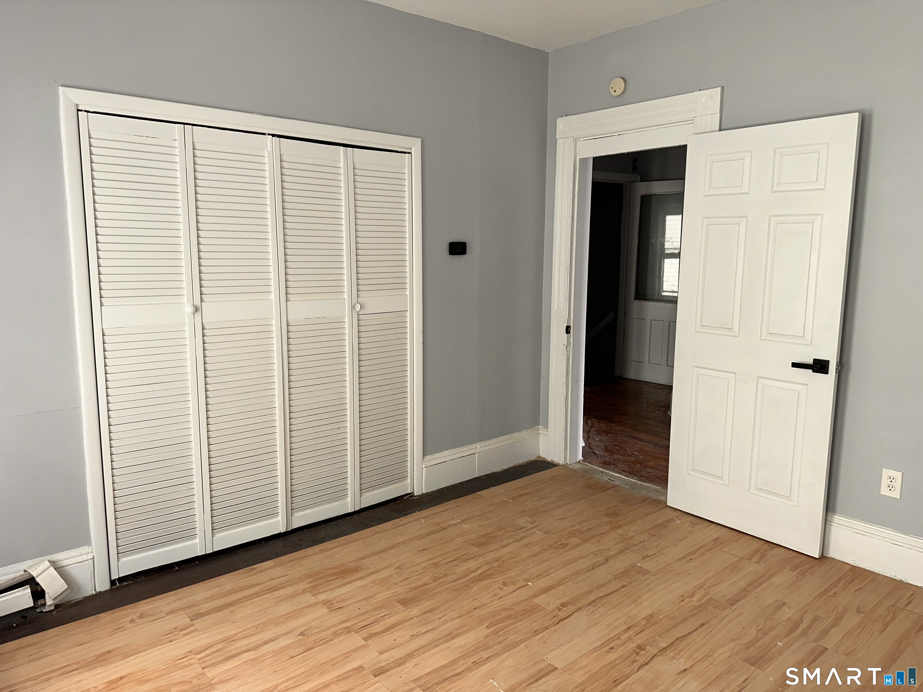 240 Madison Avenue Bridgeport, CT 06604 - Photo 8 of 21 an empty room with wooden floor and closet area