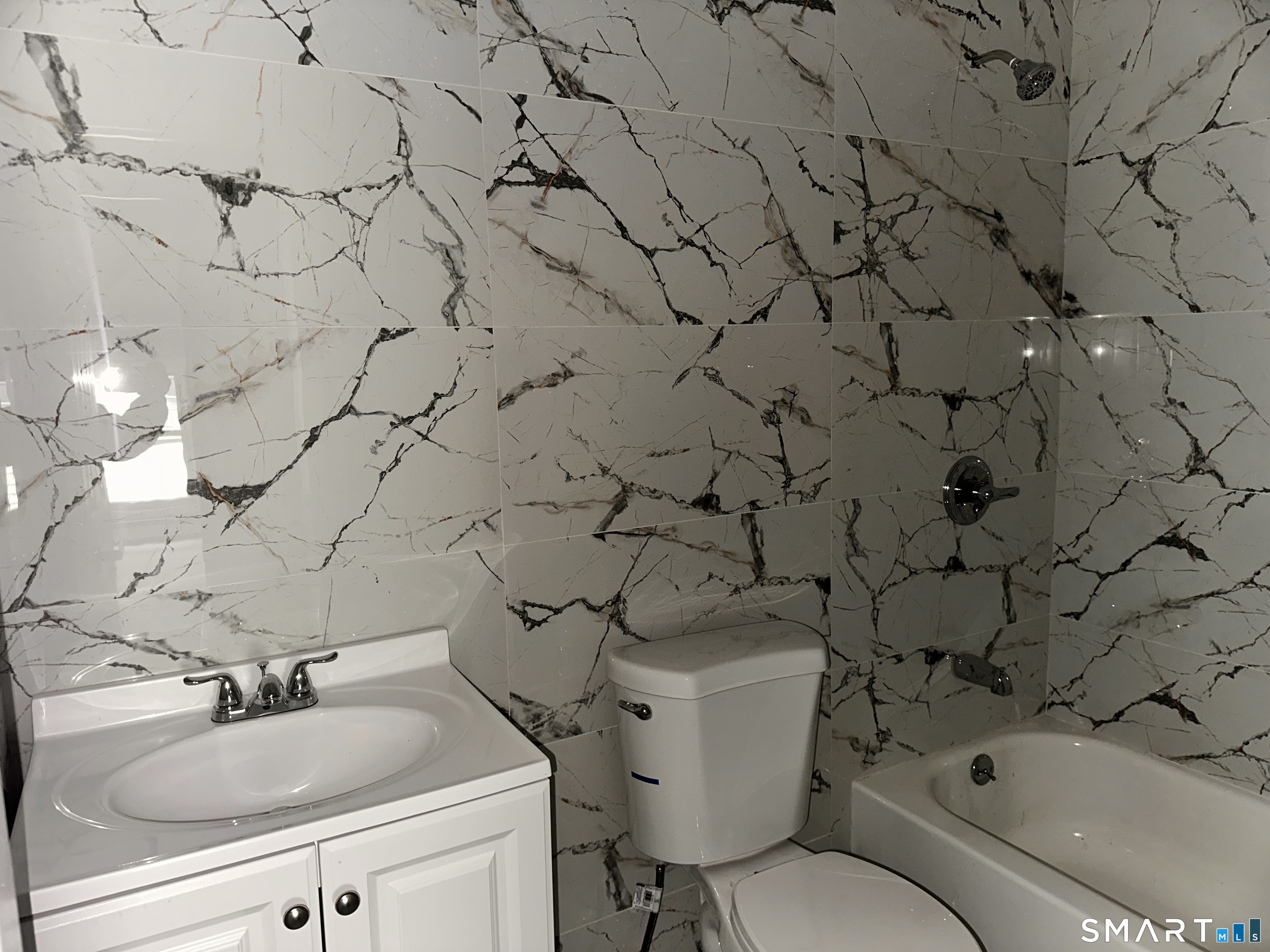 240 Madison Avenue Bridgeport, CT 06604 - Photo 10 of 21 a bathroom with a sink and mirror with toilet