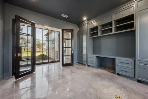 a view of an empty room with a fireplace and a window