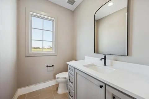 a bathroom with a sink toilet and vanity