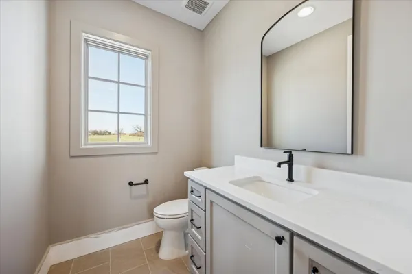 a bathroom with a sink toilet and vanity