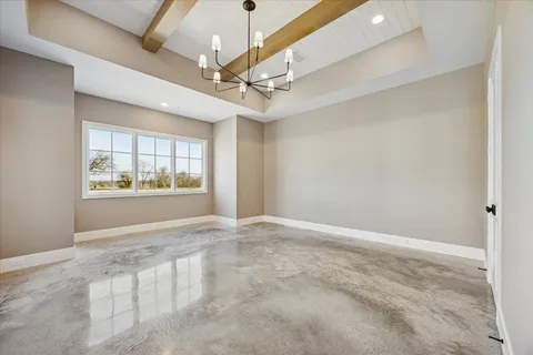 en empty room with windows and ceiling fan