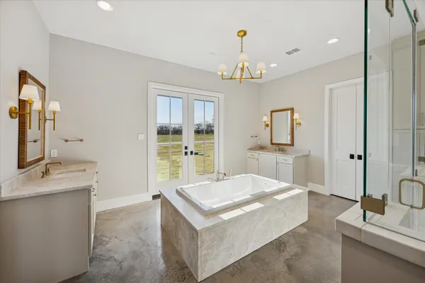 a living room with kitchen island granite countertop furniture and a chandelier