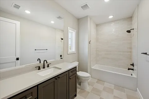 a bathroom with a double vanity sink toilet and shower