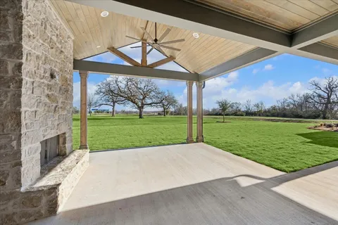 a view of a backyard with a garden and entertaining space