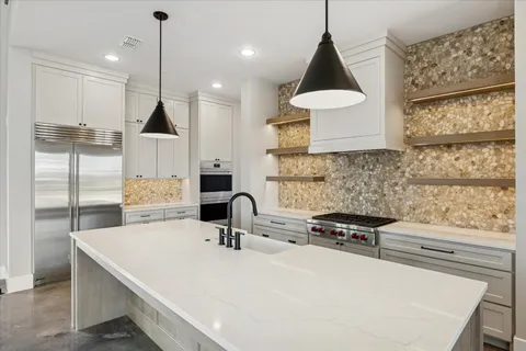 a kitchen with a sink a stove and a refrigerator