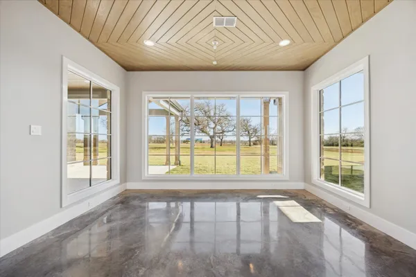 an empty room with large windows