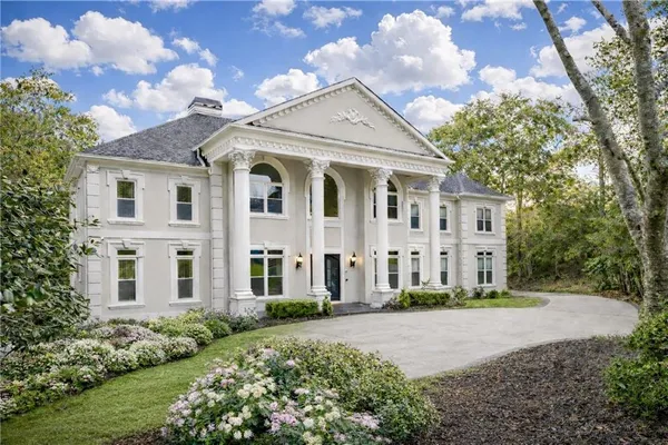 a front view of a house with a garden