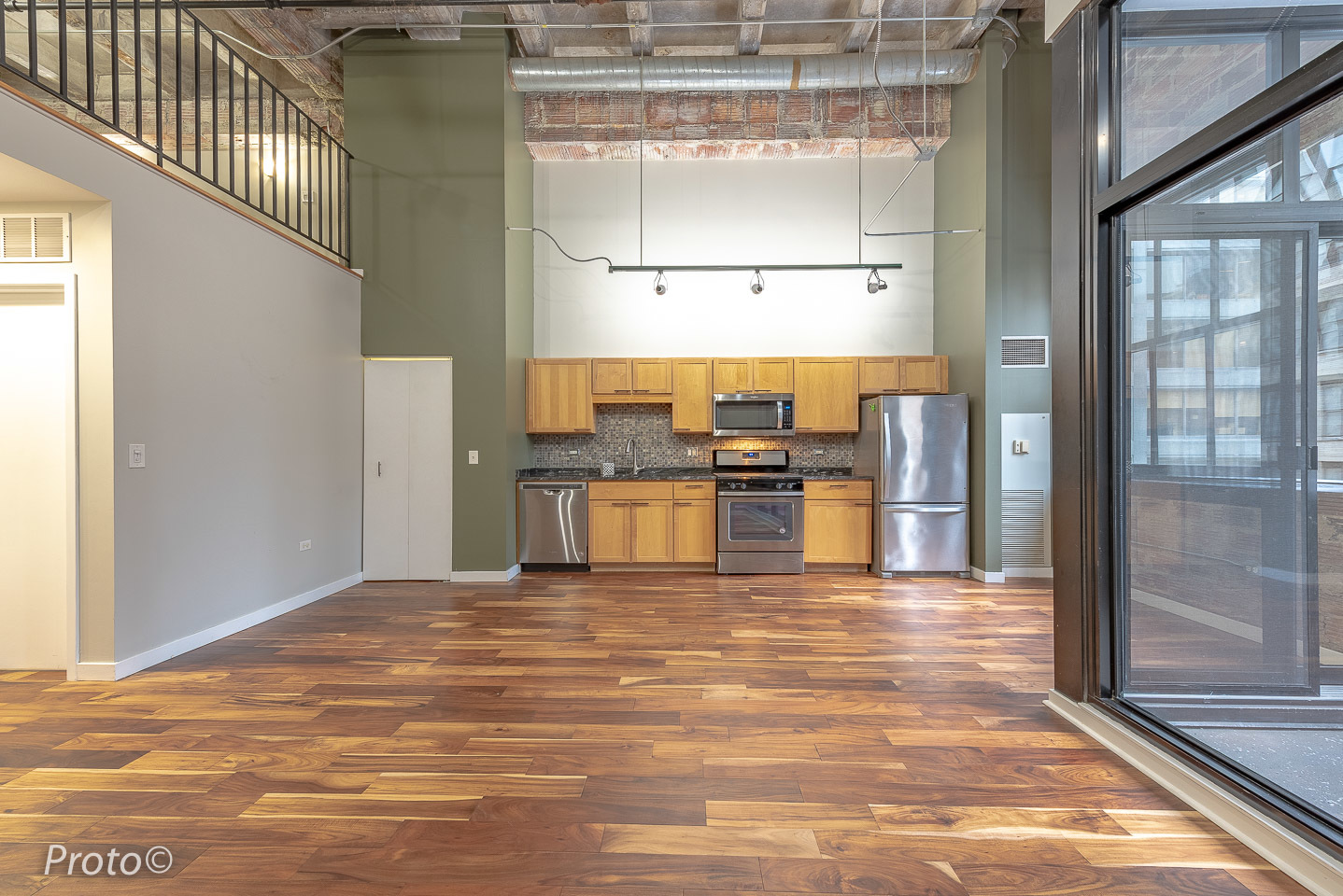 20 North State Street, Unit 1012 Chicago, IL 60602 - Photo 5 of 26 a kitchen with stainless steel appliances kitchen island granite countertop a refrigerator and cabinets