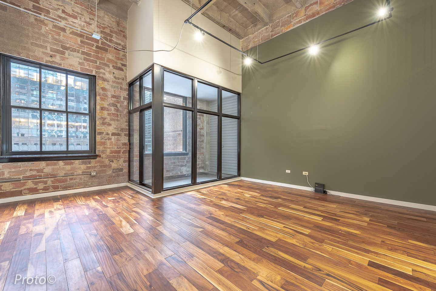 20 North State Street, Unit 1012 Chicago, IL 60602 - Photo 6 of 26 a view of an empty room with wooden floor and a window