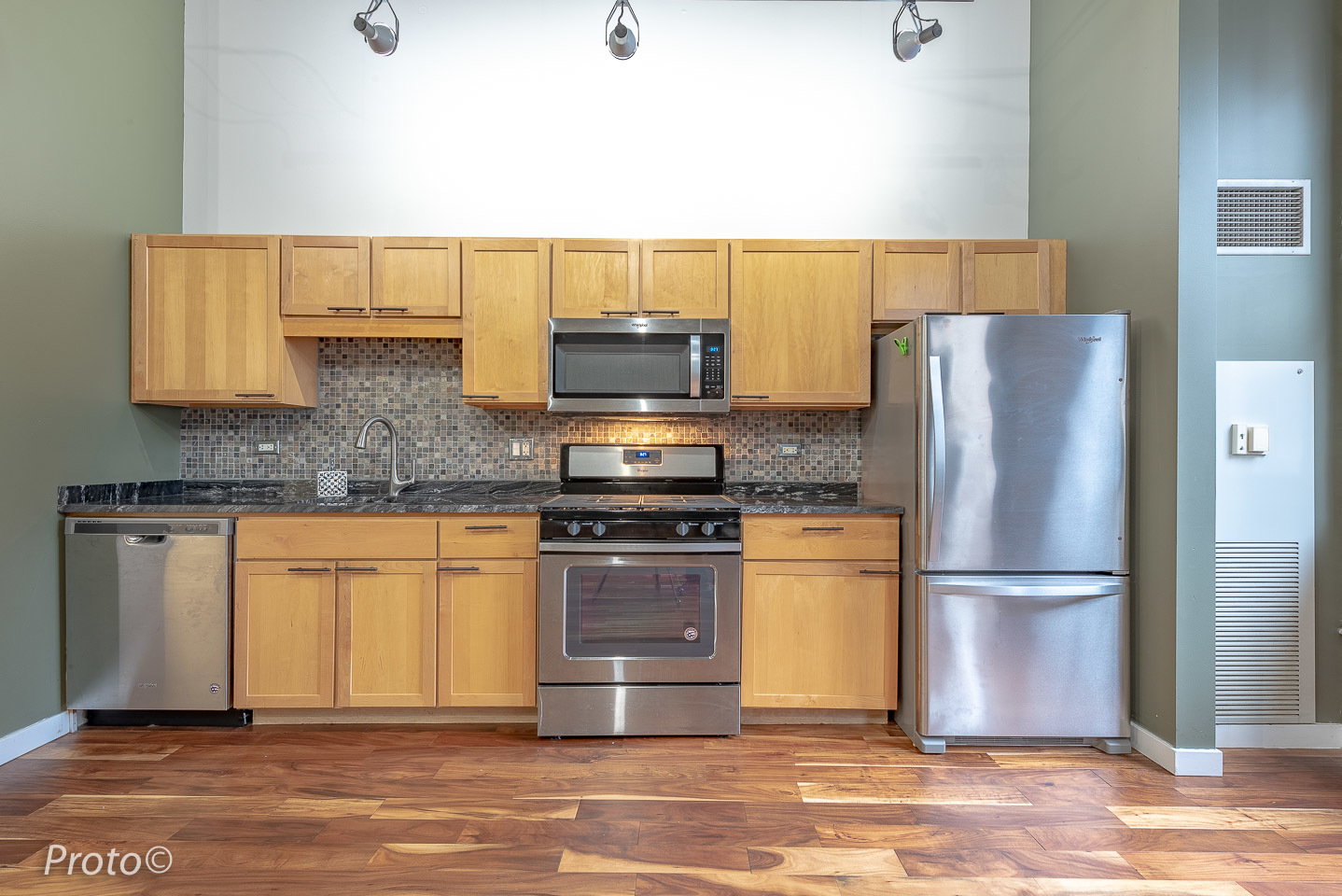 20 North State Street, Unit 1012 Chicago, IL 60602 - Photo 8 of 26 a kitchen with stainless steel appliances granite countertop a refrigerator stove a sink and a microwave