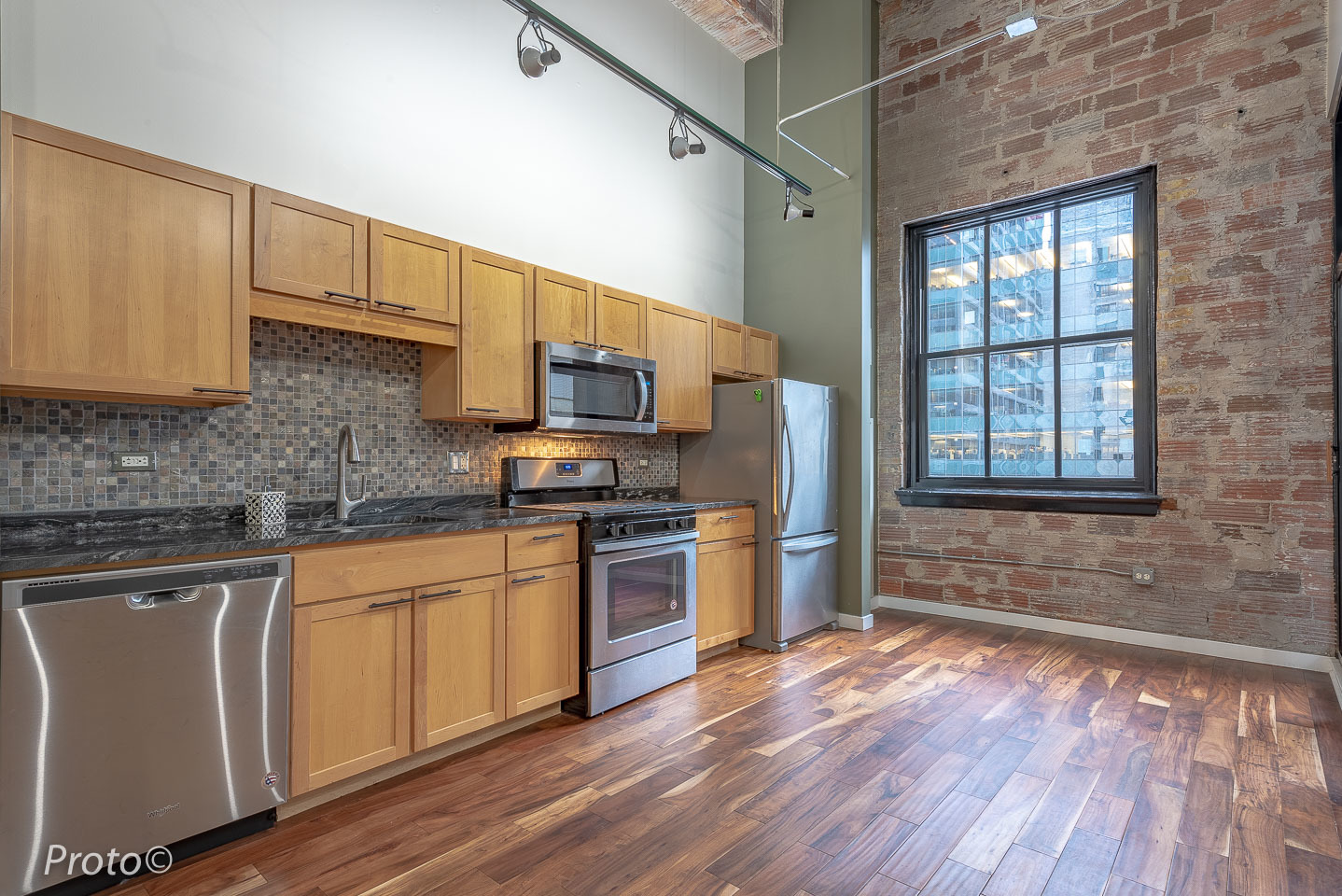 20 North State Street, Unit 1012 Chicago, IL 60602 - Photo 9 of 26 a kitchen with stainless steel appliances granite countertop a stove a sink dishwasher a microwave oven and a refrigerator with wooden floor